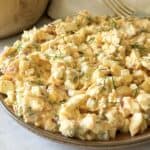 Dill pickle egg salad on a plate with a fork in the background.