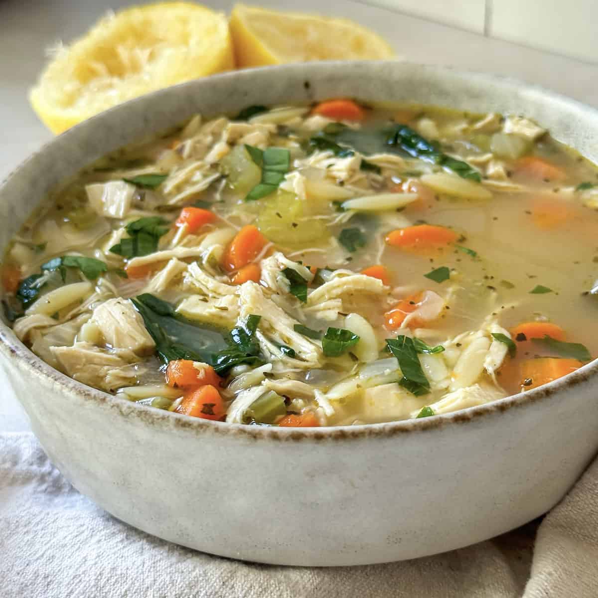 45 degree angle view of lemon chicken orzo soup.