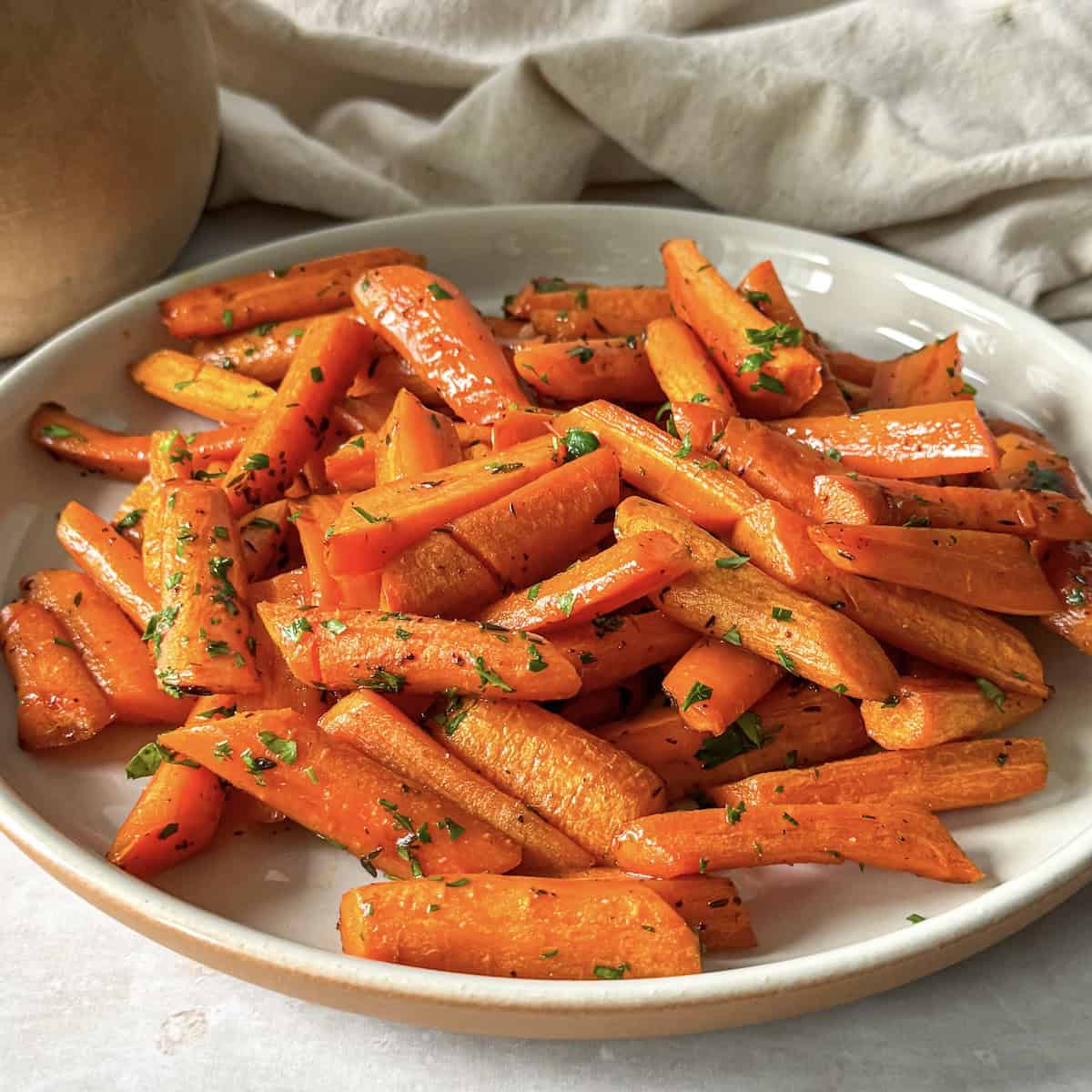 Honey Glazed Carrots with Thyme on a plate.