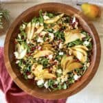 overhead view of pear and arugula salad with dressing.