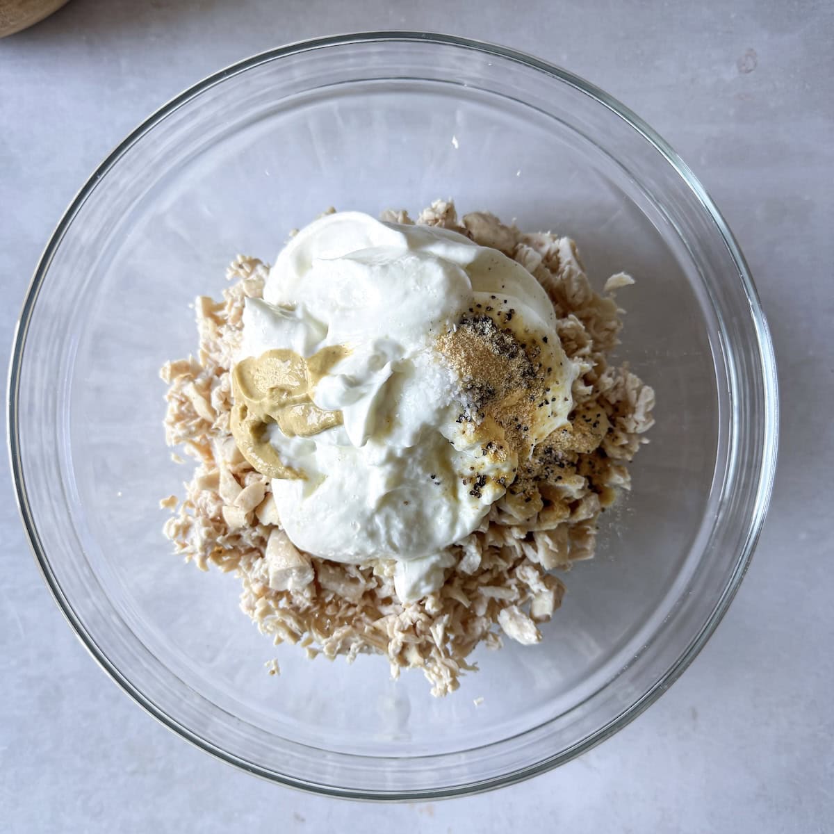 overhead view of chicken salad ingredients in a bowl.