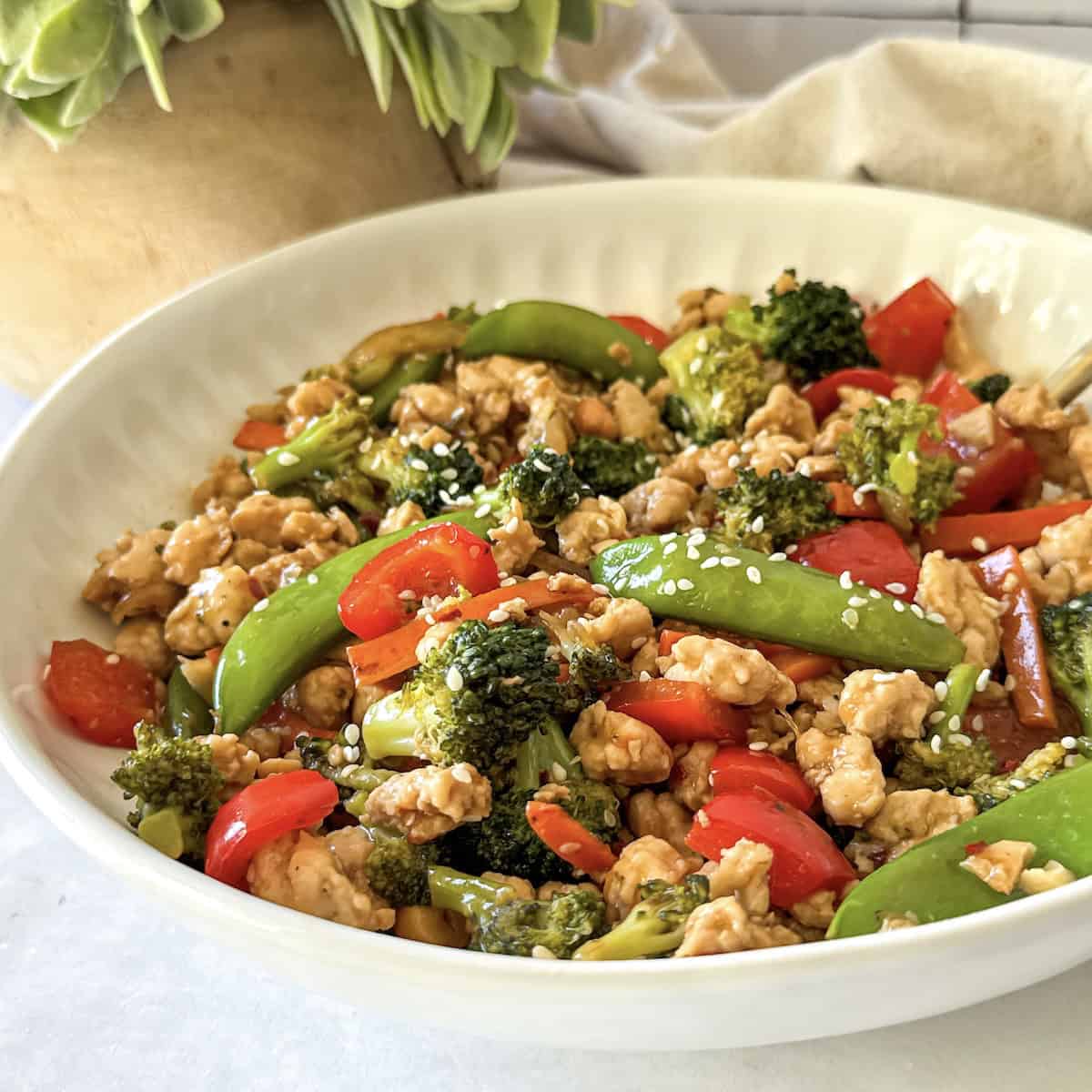 45 degree angle view of ground chicken stir fry in a bowl.