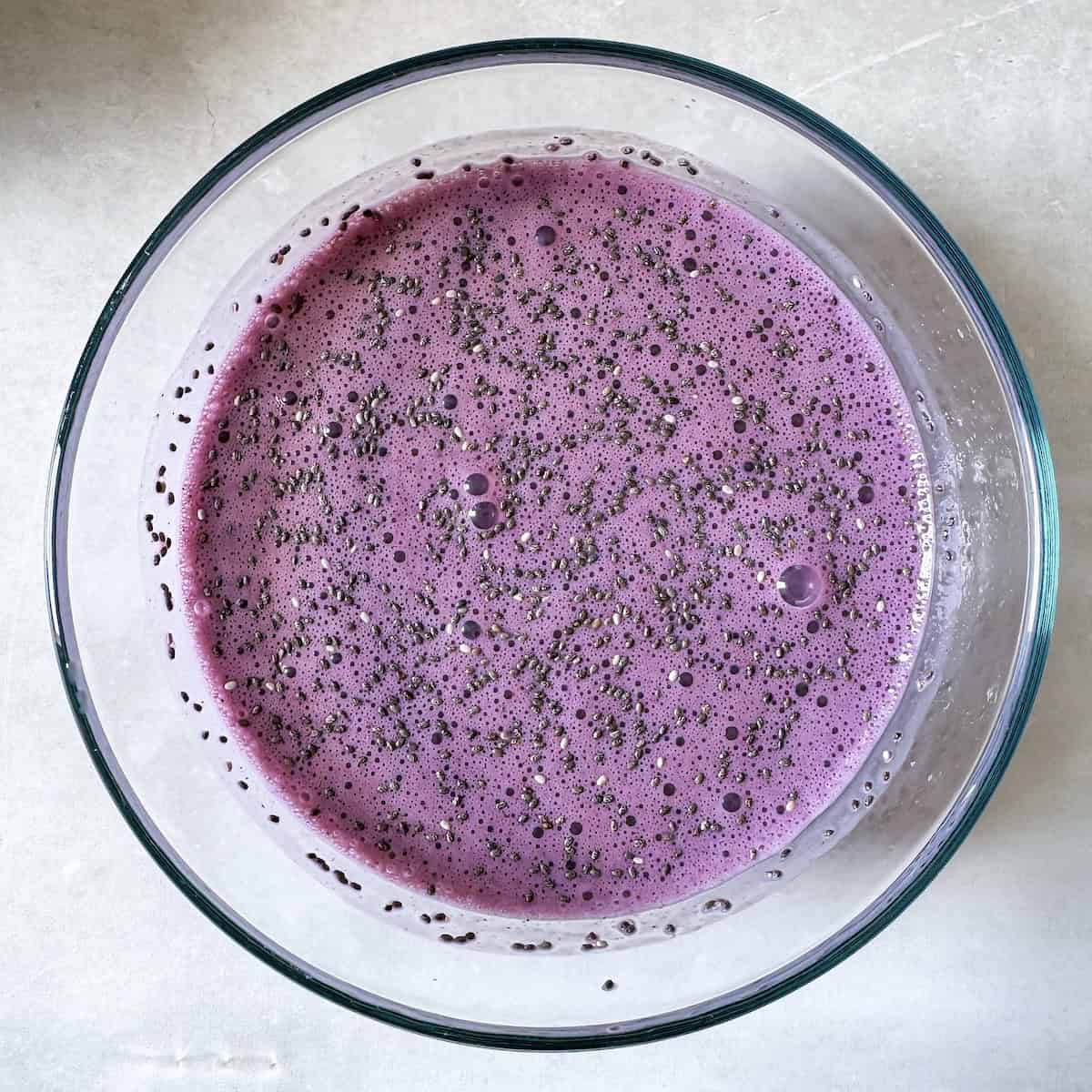 blueberry chia pudding in a glass bowl.