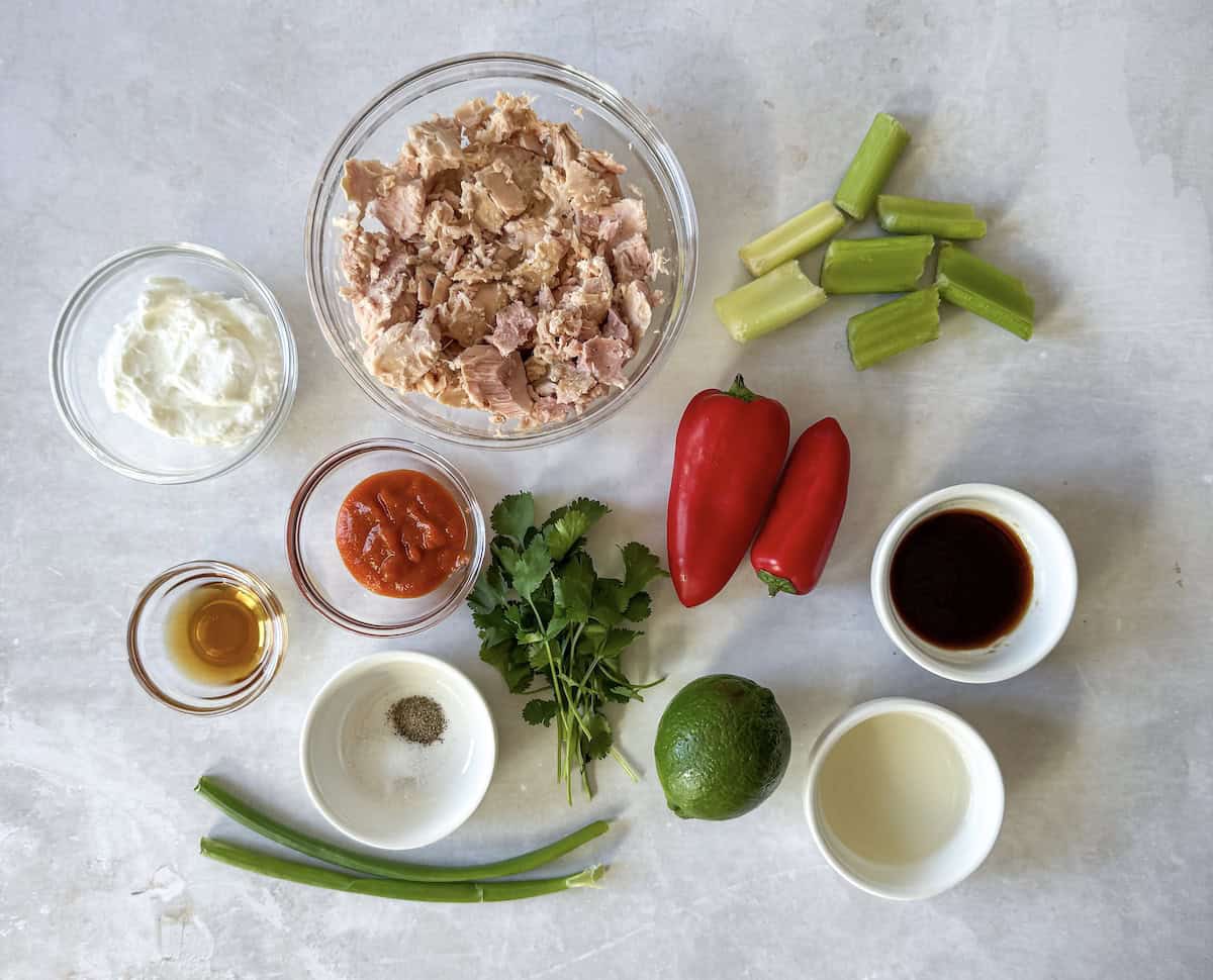 ingredients for spicy tuna salad on a table.