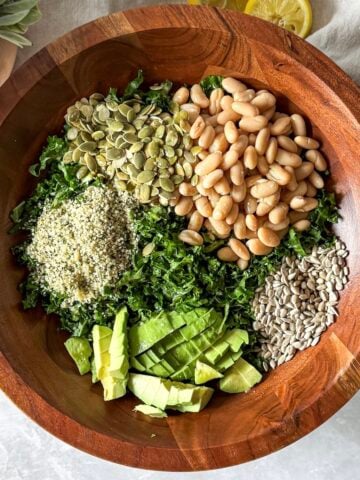 kale and white bean salad with dressing on top (overhead view)