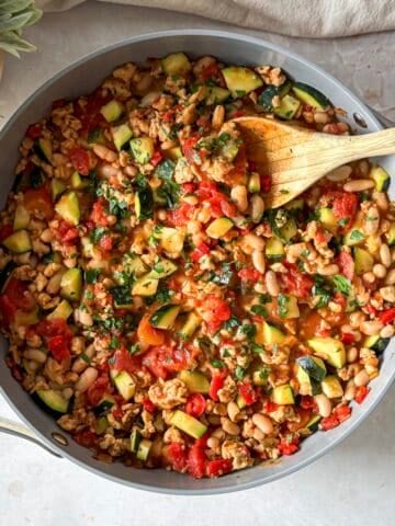 overhead view of turkey zucchini skillet with wooden spoon in it.