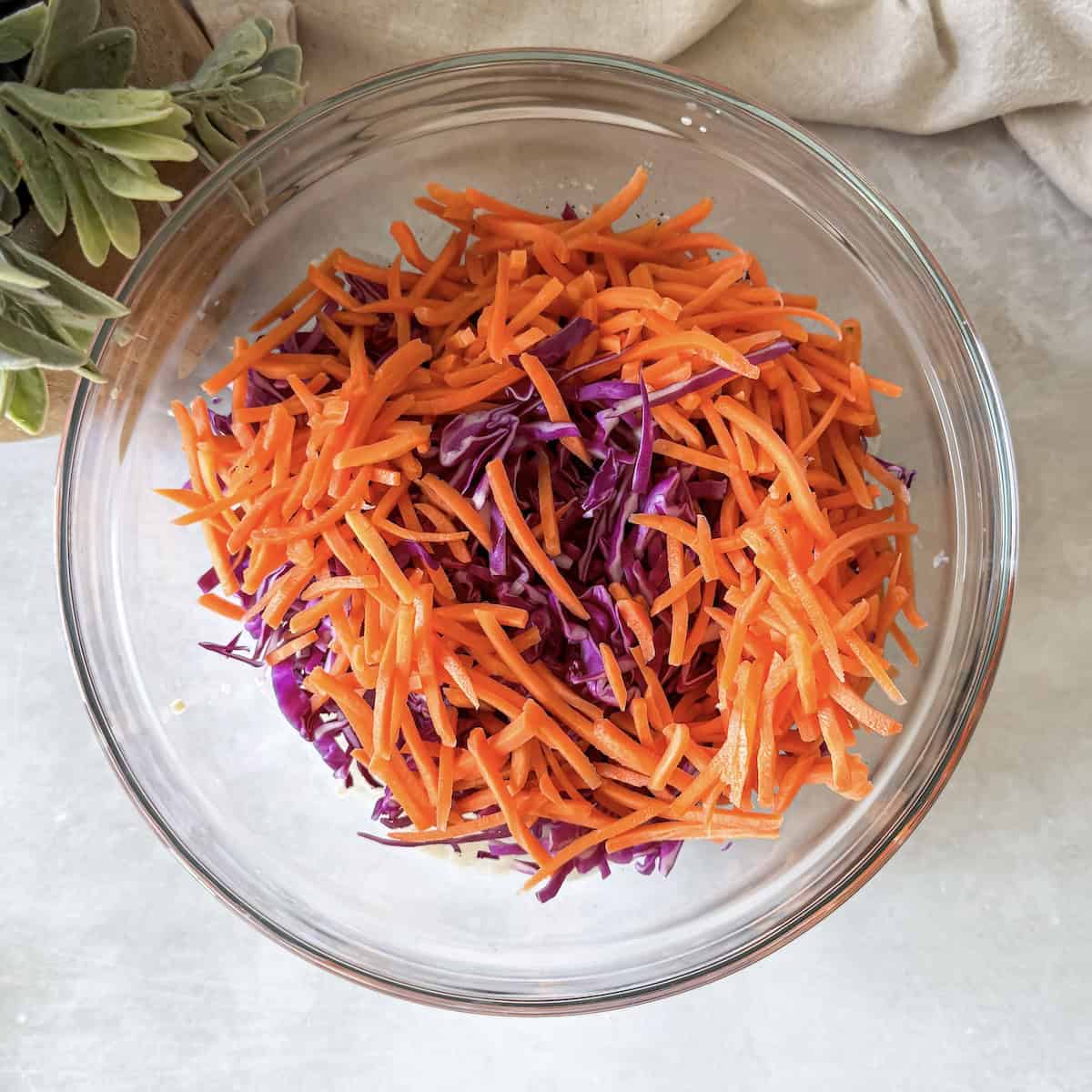 carrots and purple cabbage in a glass bowl.