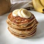 stack of banana oatmeal pancakes on a table.