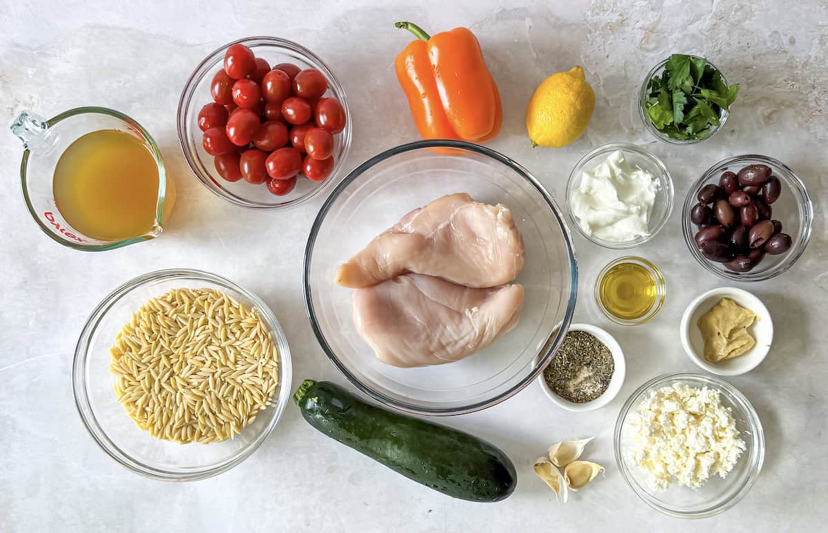 Ingredients for Greek Lemon Chicken Orzo Pasta Bake on a table.
