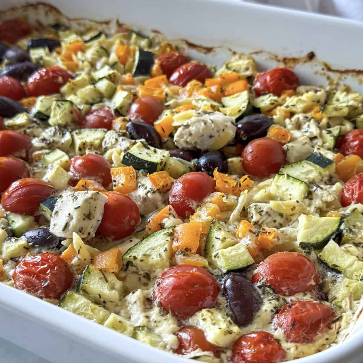 baked greek chicken orzo pasta in a baking dish.