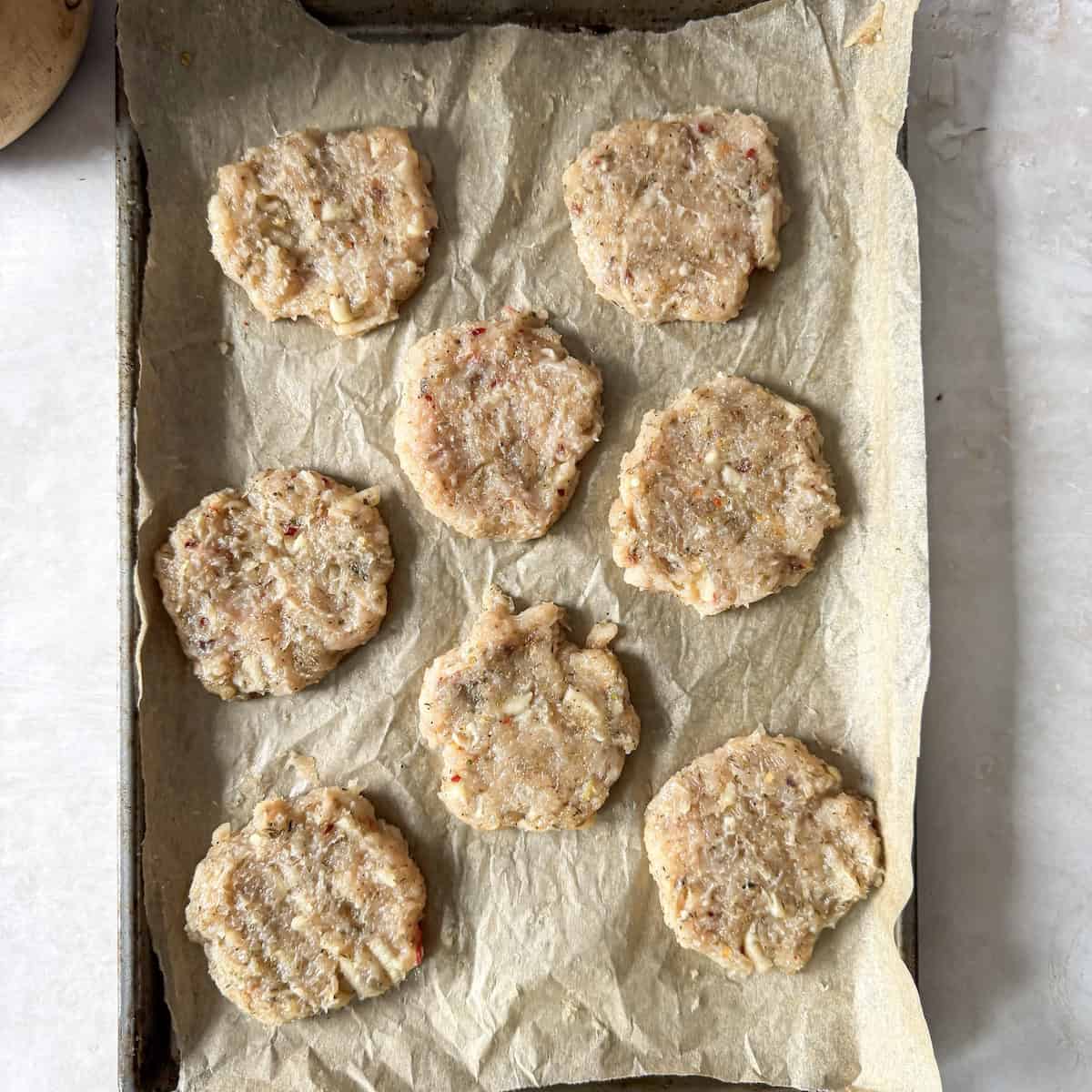 chicken breakfast sausage patties on a baking sheet.