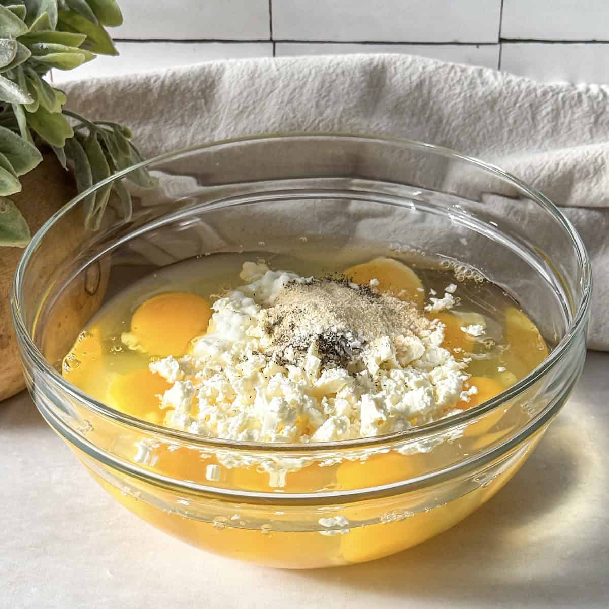 eggs and cheese in a glass bowl.
