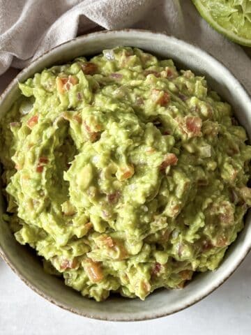 overhead view of homemade guacamole without cilantro in a bowl.