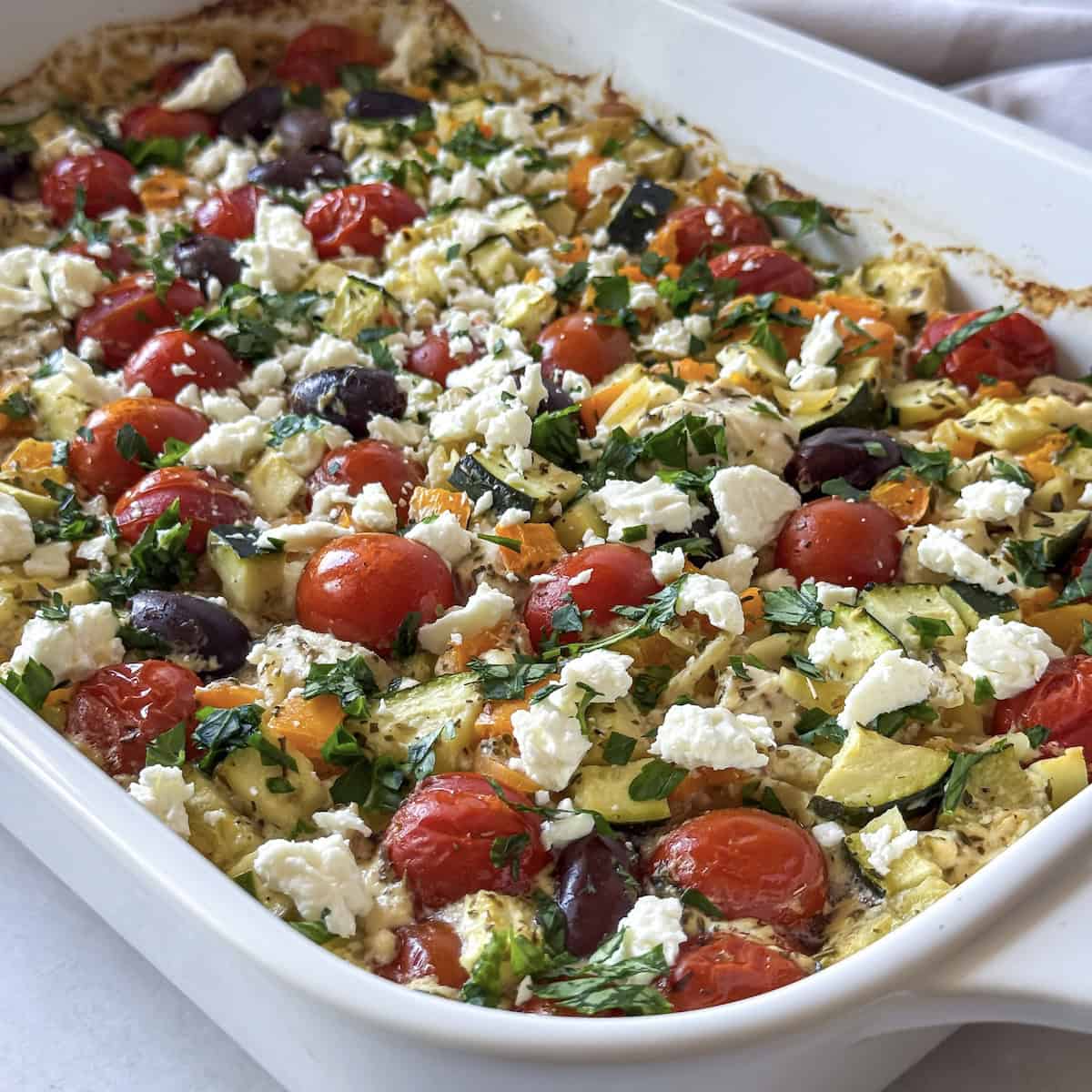 side view of Greek lemon chicken orzo bake close up.