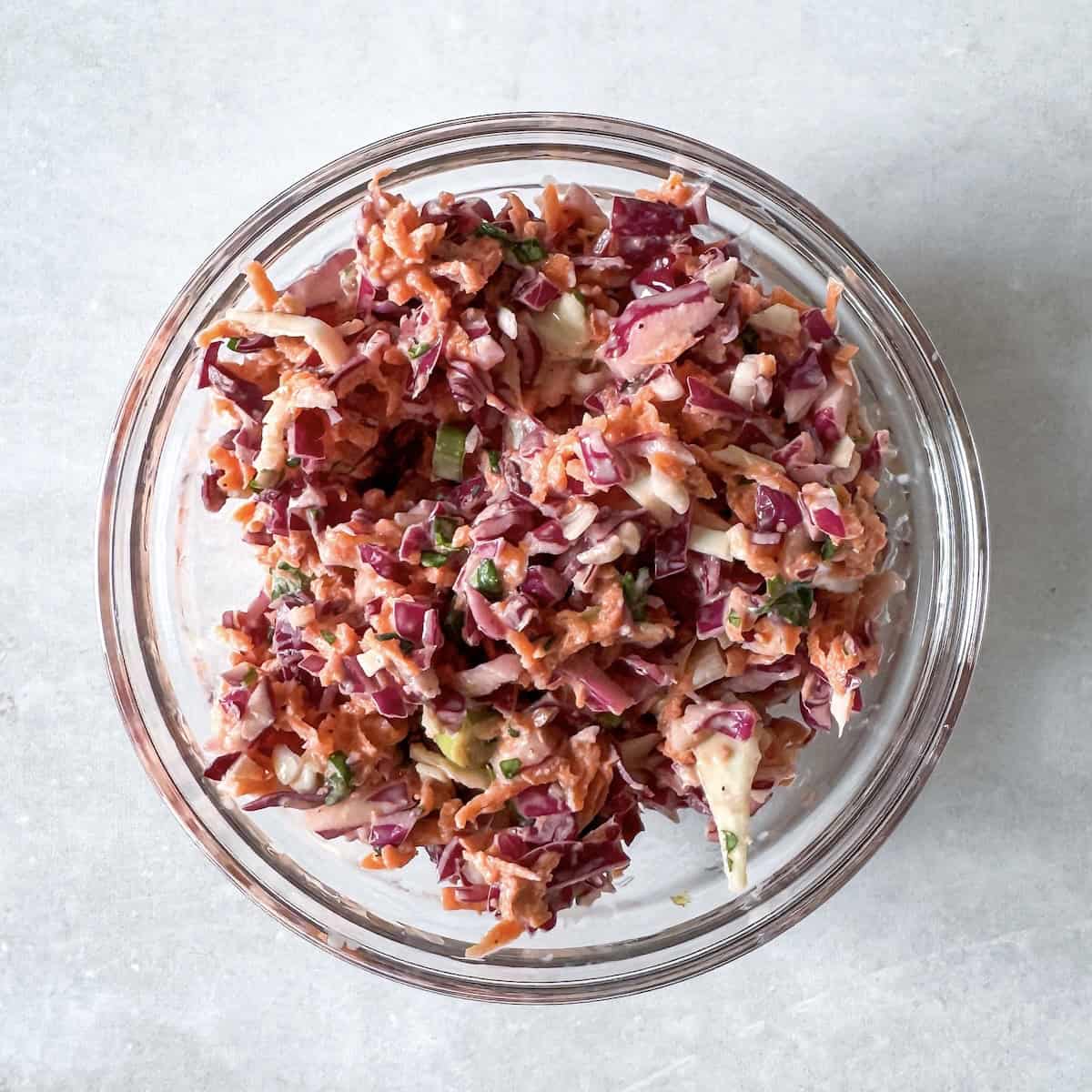 cabbage coleslaw in a small glass bowl.