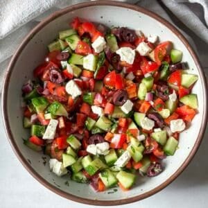 overhead view of cucumber and tomato salad with feta.
