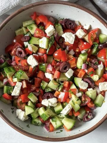 overhead view of cucumber and tomato salad with feta.