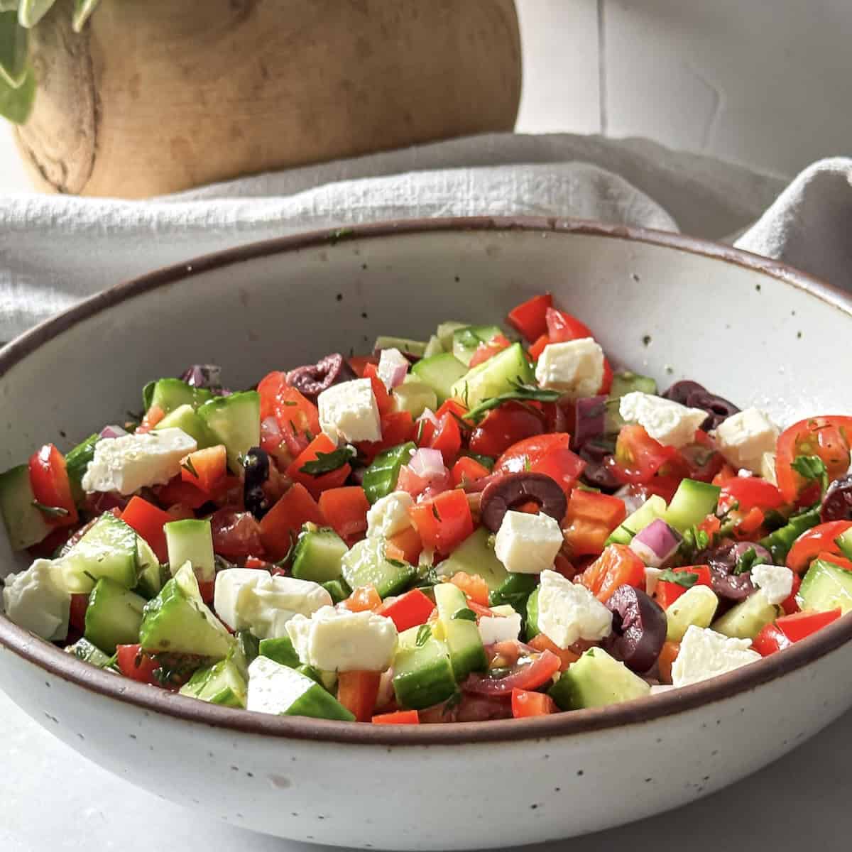 side view of cucumber and tomato salad with feta.