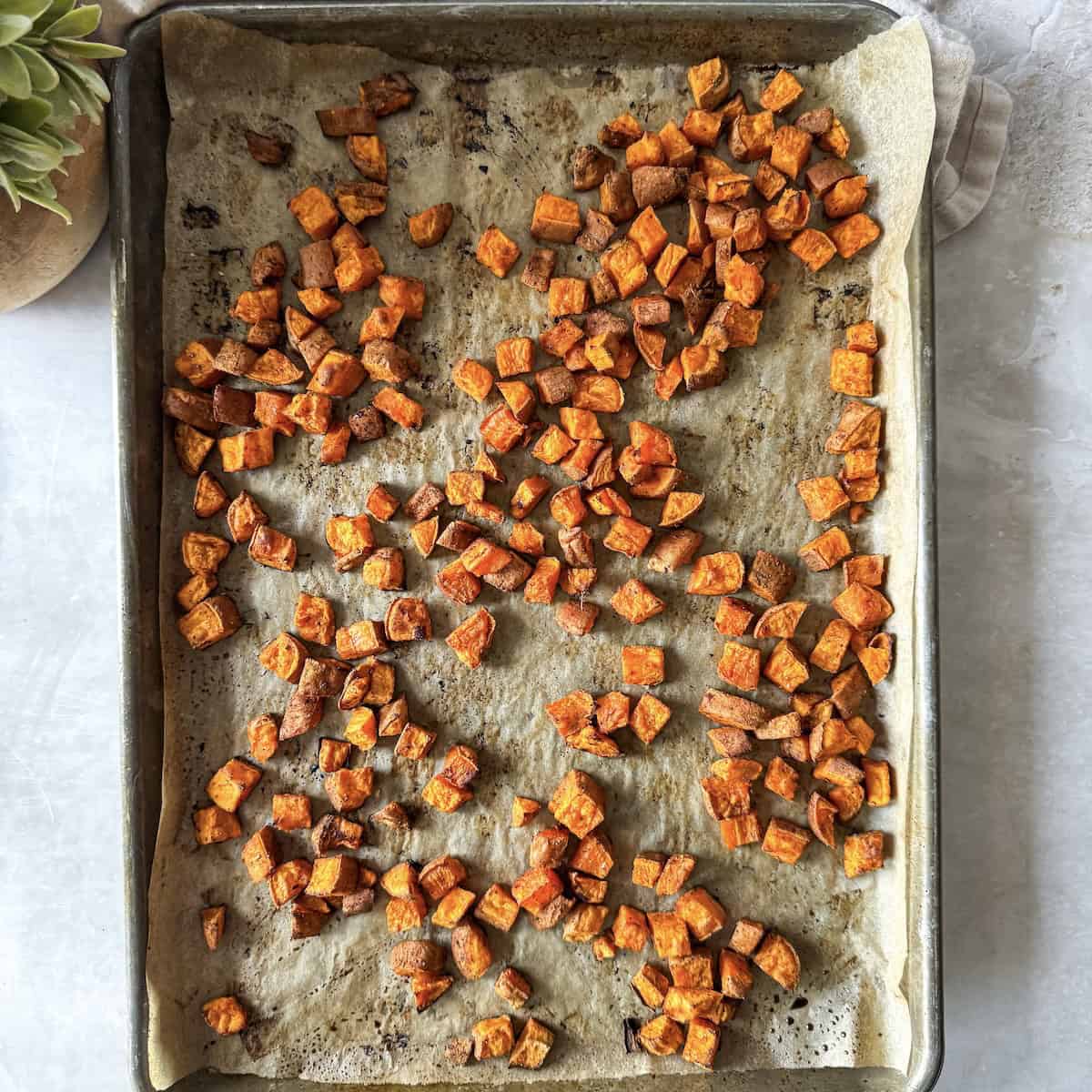 sweet potatoes cooked on a baking sheet.