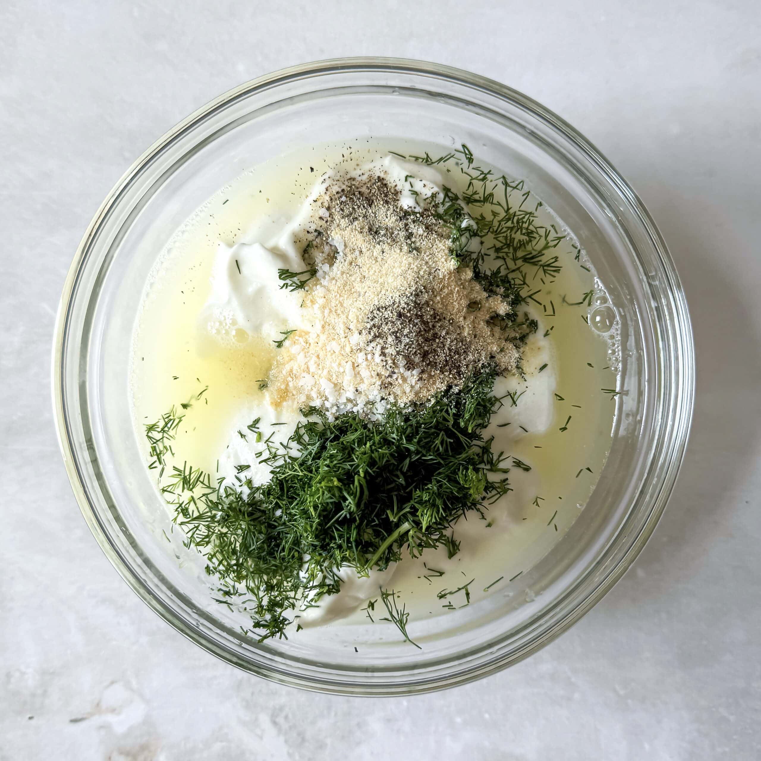 Ingredients for yogurt dill sauce in a small bowl.