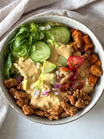 big mac burger bowl with special sauce, overhead view further away.