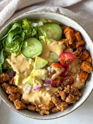 big mac burger bowl with special sauce, overhead view without sauce in background.