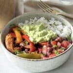 close up side view of chicken fajita bowls.