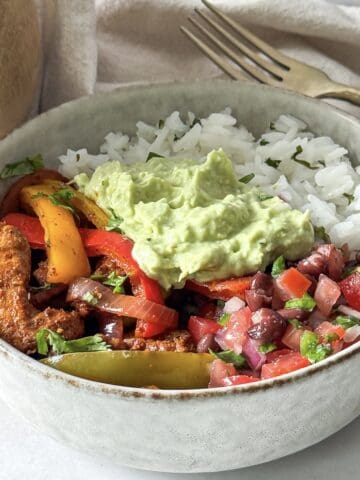 close up side view of chicken fajita bowls.