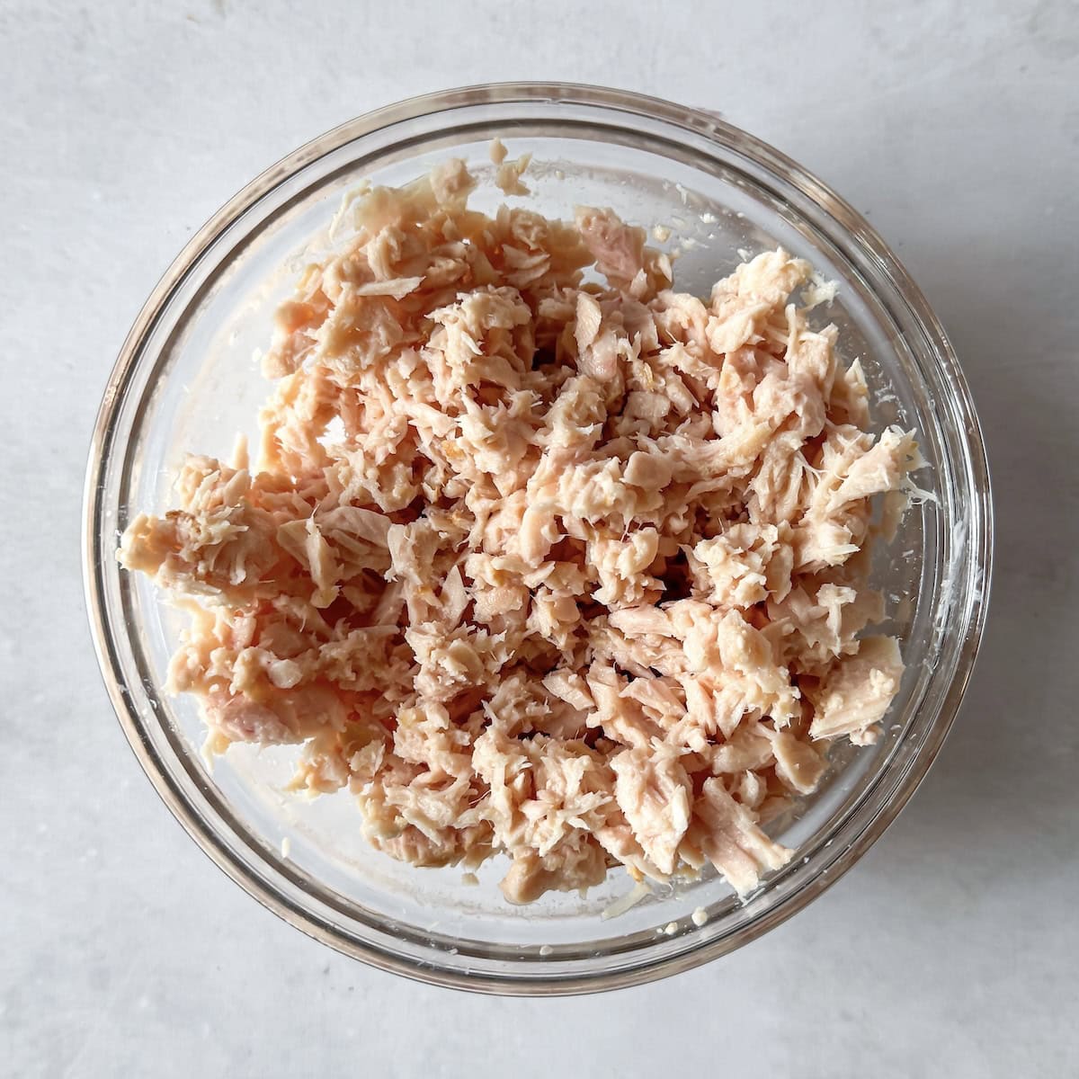 flaked tuna in a glass bowl.