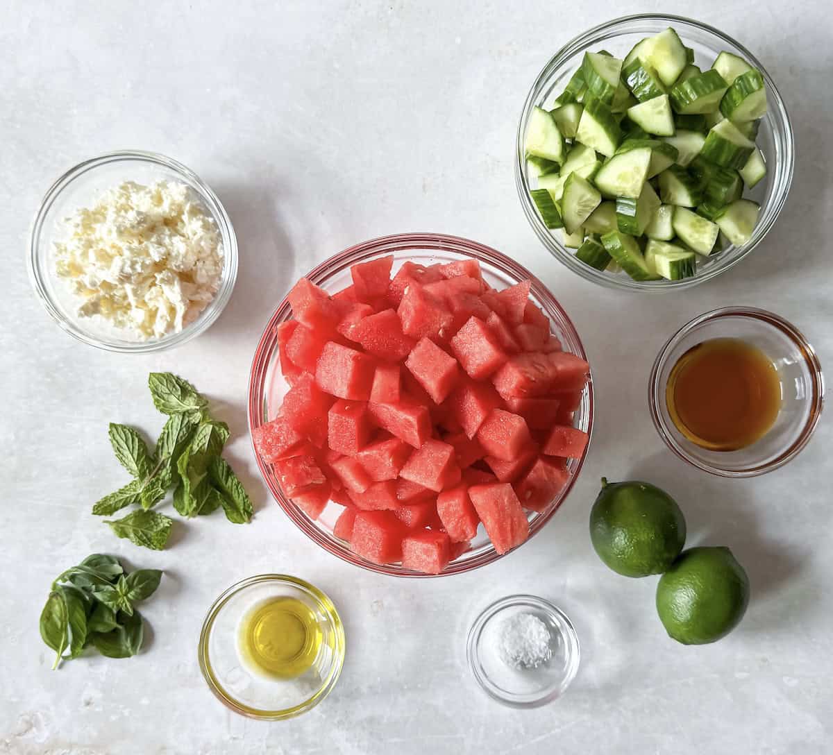 ingredients for watermelon cucumber salad on a table.
