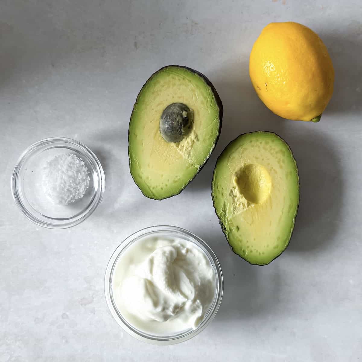 overhead view of avocado mash ingredients on a table.