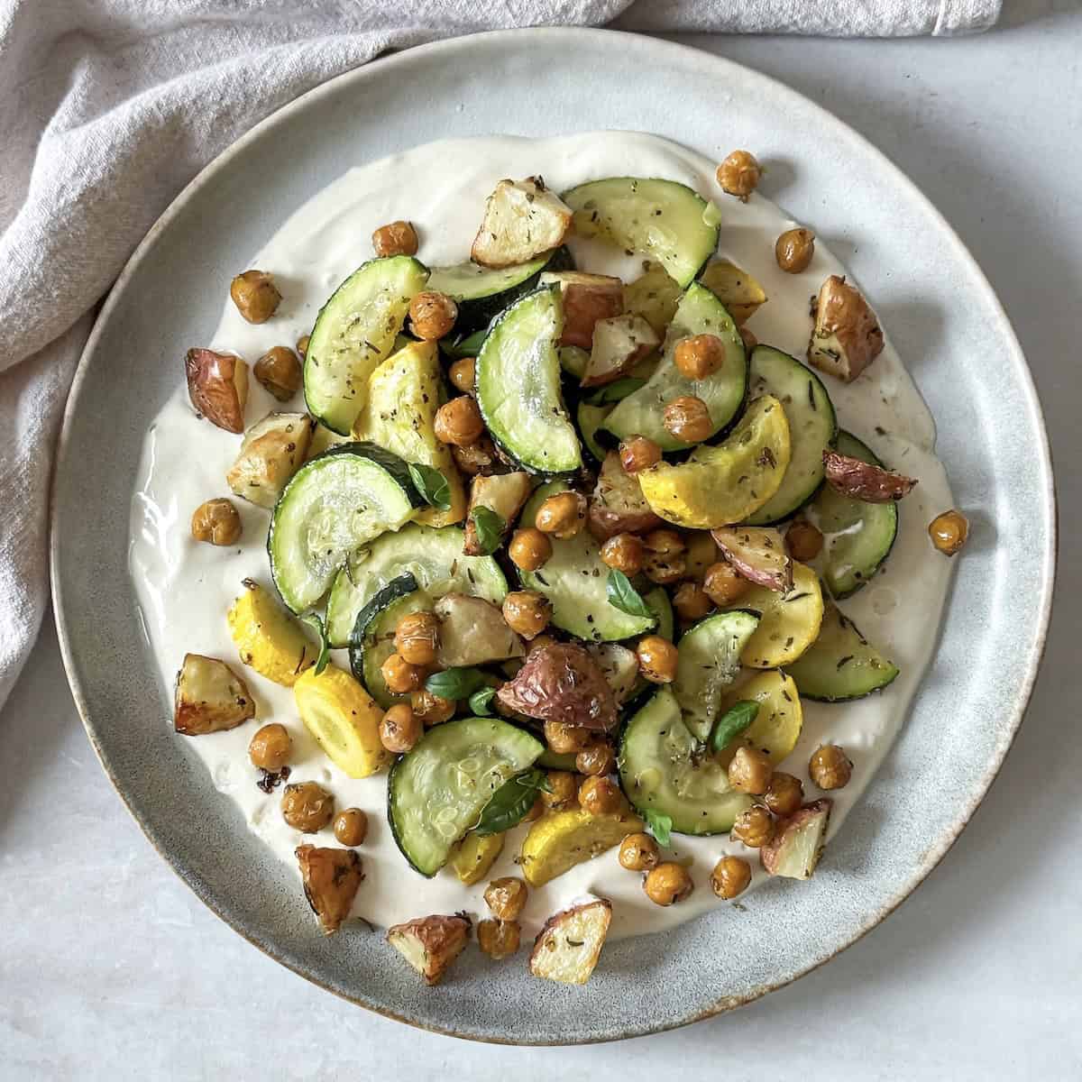 overhead view of roasted zucchini salad on a plate.