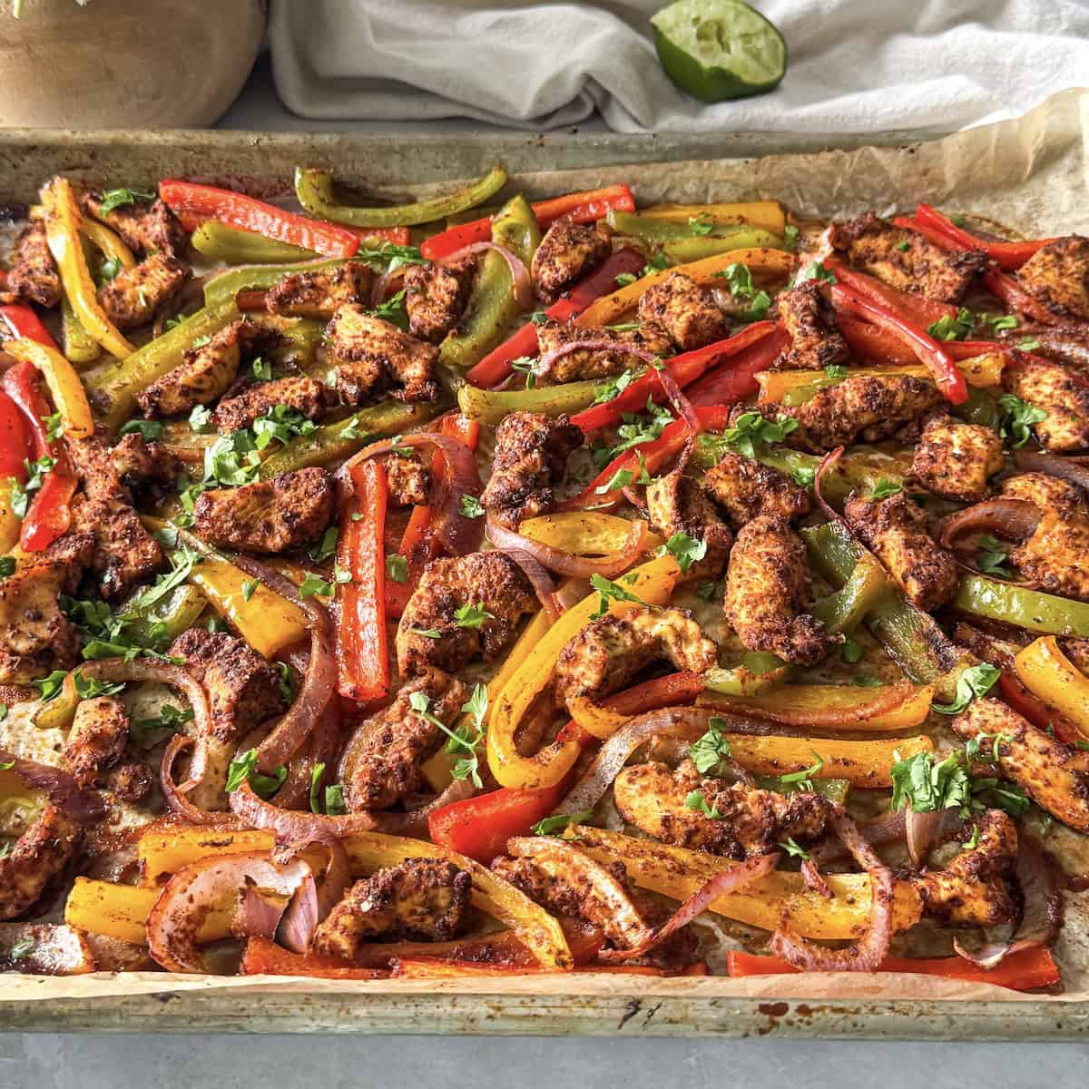 side view of sheet pan chicken fajitas.