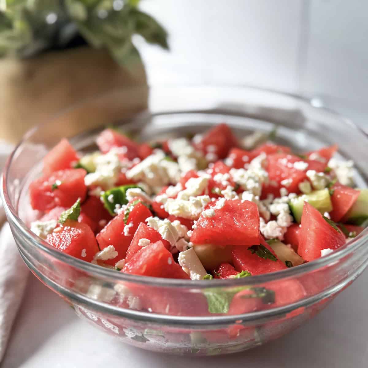 watermelon cucumber salad in a glass bowl..