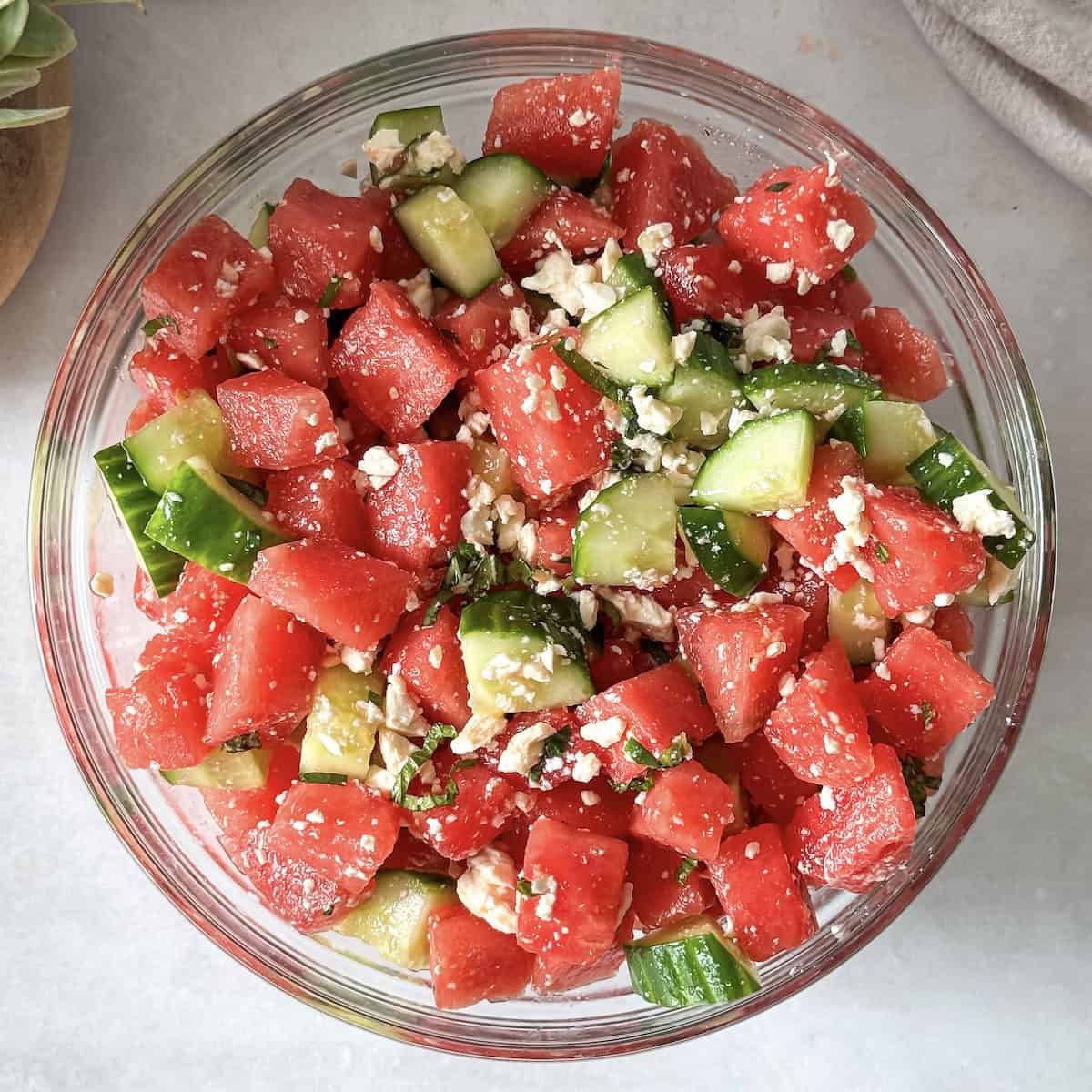 watermelon cucumber salad in a glass bowl bright.
