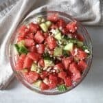 watermelon cucumber salad in a glass bowl further away.