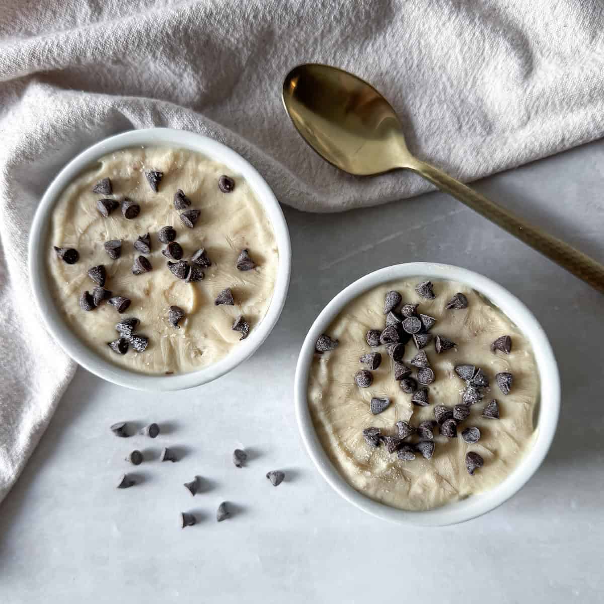 2 small white bowls with salted caramel frozen yogurt in them. Overheaad view.