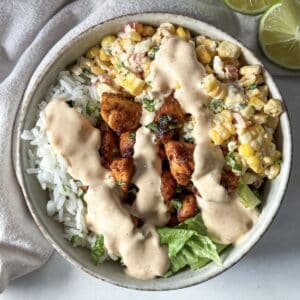 close up overhead view of street corn chicken rice bowl.