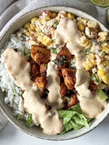 close up overhead view of street corn chicken rice bowl.
