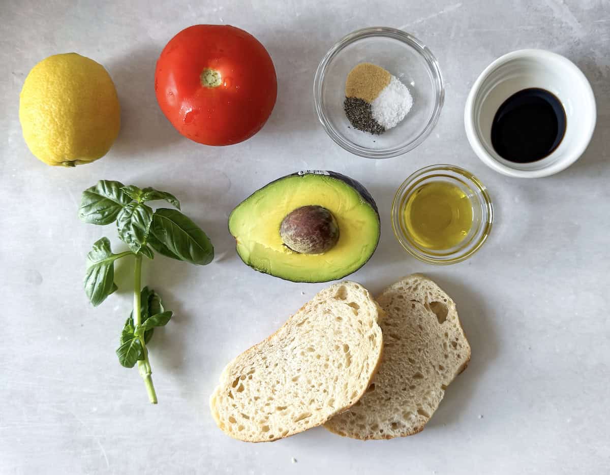 ingredients for avocado tomato toast on a table.