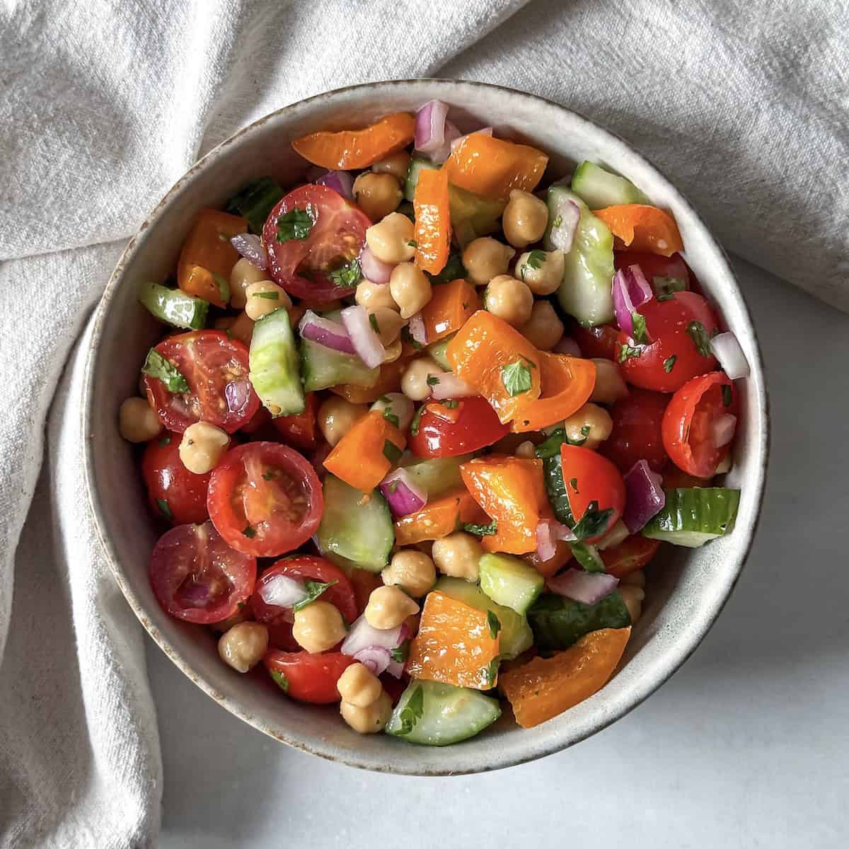 overhead view of chickpea salad with cilantro in a bowl.