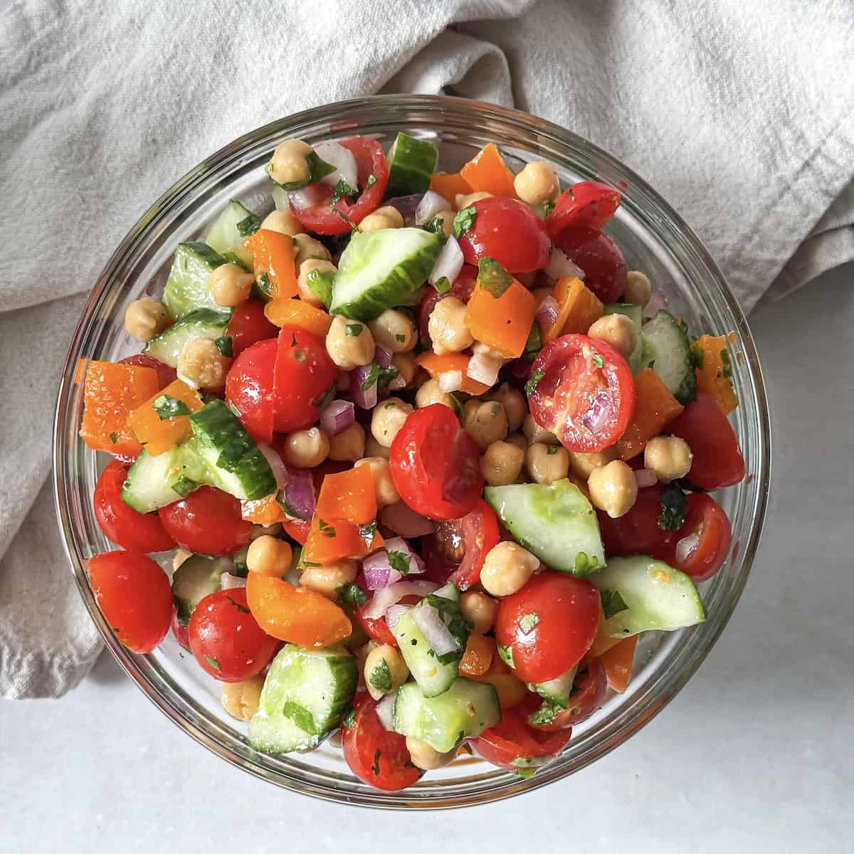 overhead view of chickpea salad with cilantro in a glass bowl.