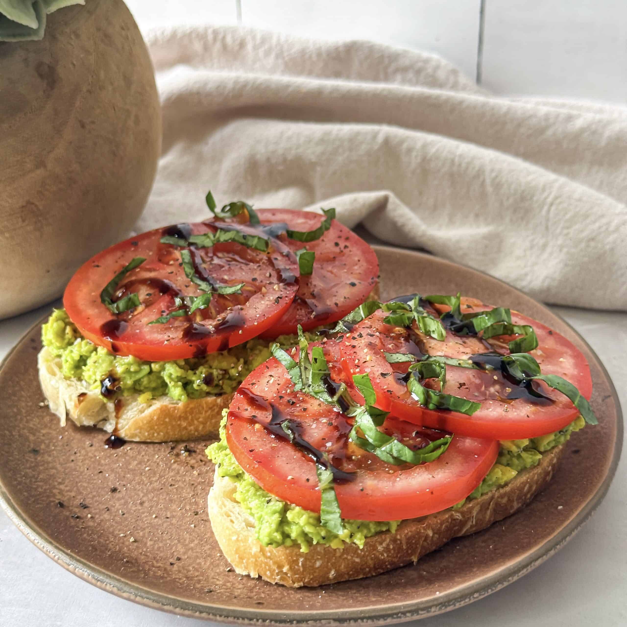 side view of avocado tomato toast with close up.
