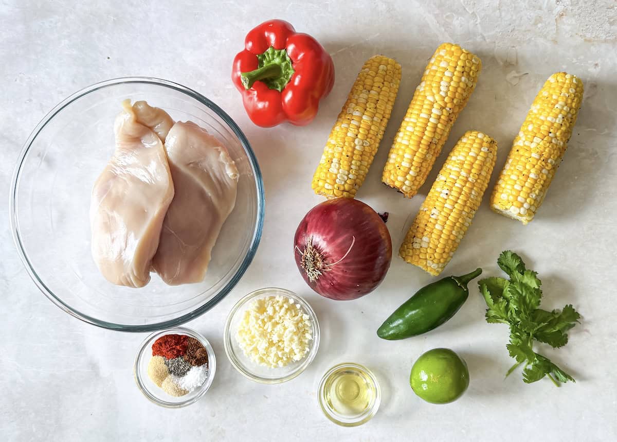 street corn chicken rice bowl ingredients on a table.
