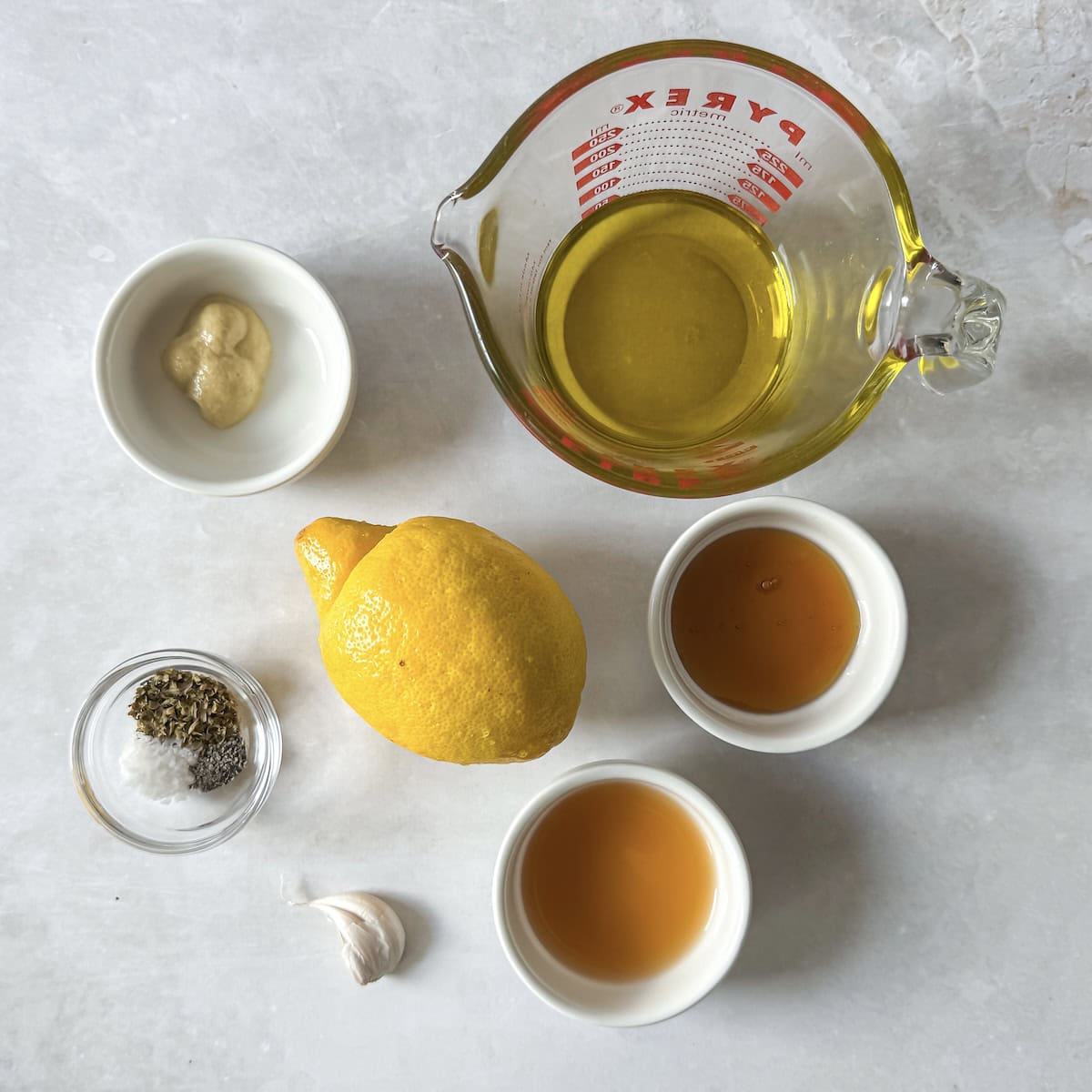 ingredients for honey lemon dressing on a table.