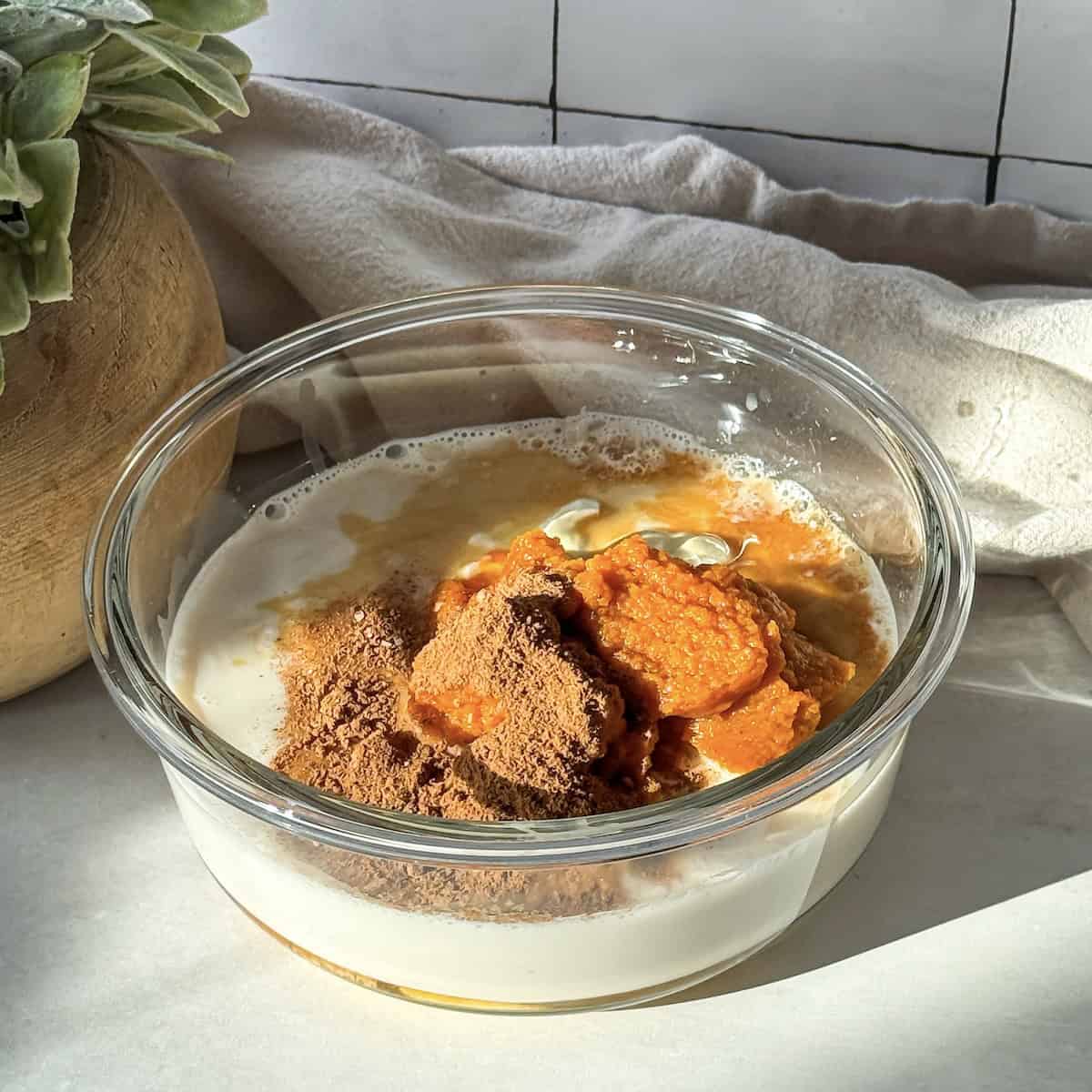 ingredients for pumpkin chia pudding in a bowl.