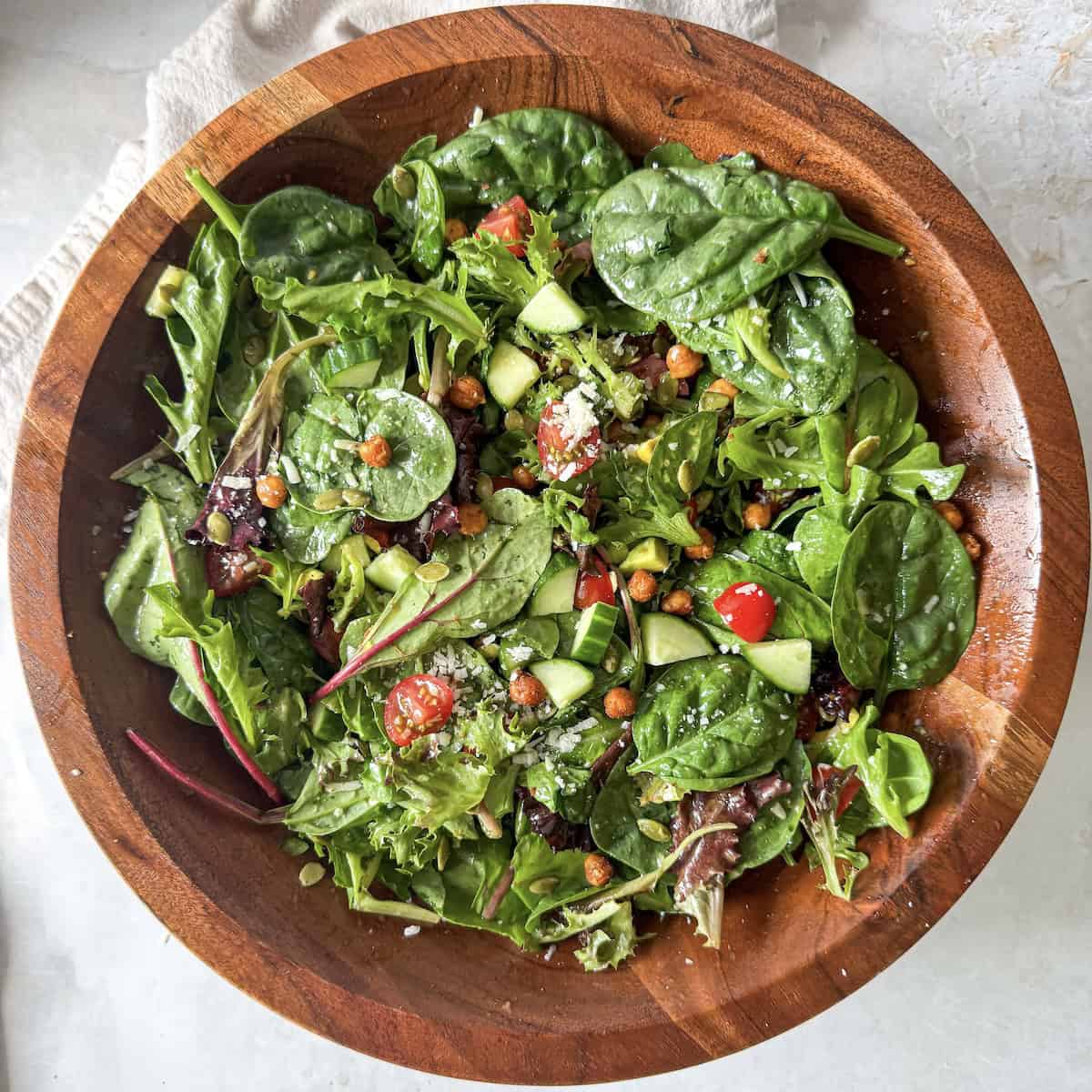 overhead view of Super Greens salad in a wooden bowl.