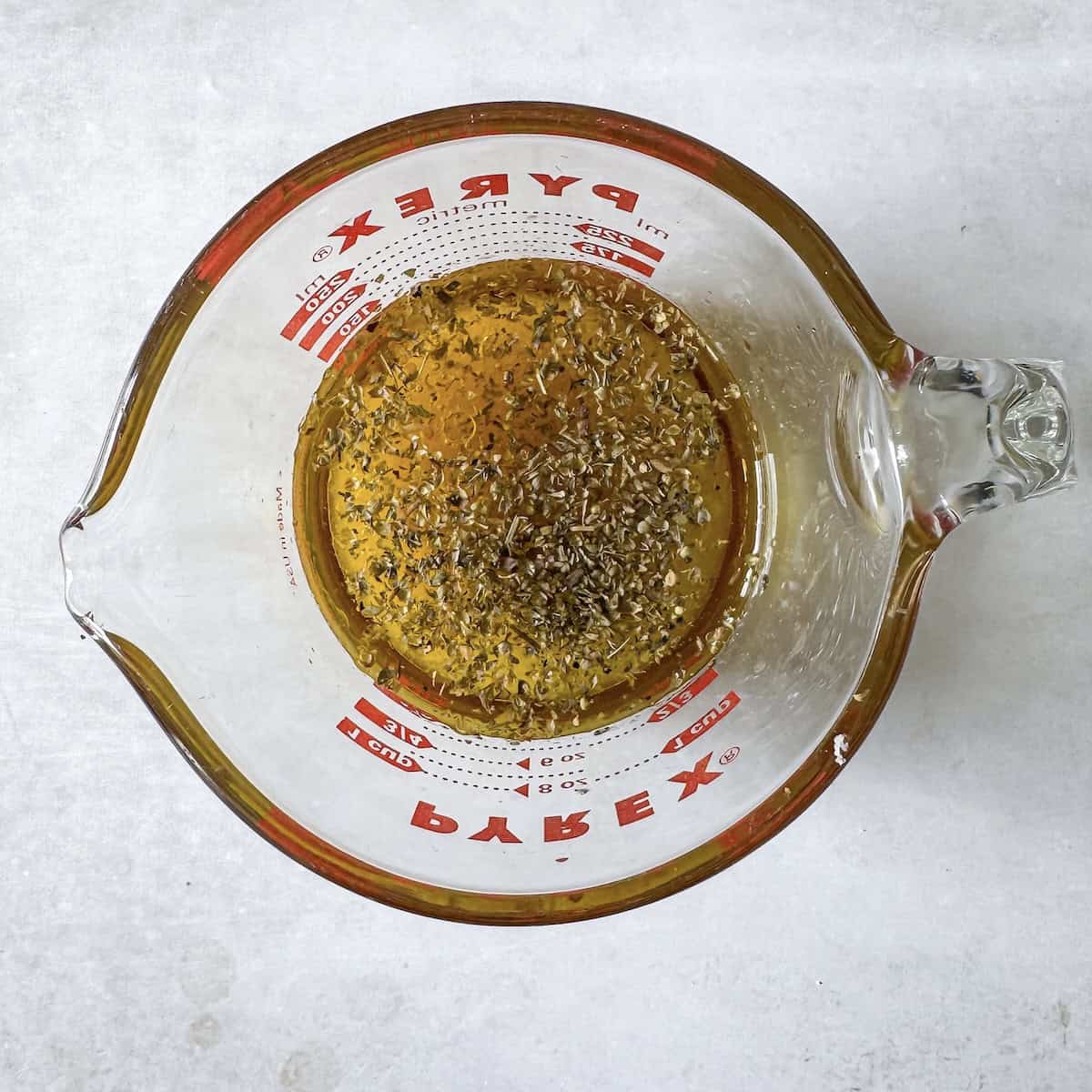 overhead view of ingredients for honey lemon dressing in a pyrex dish.