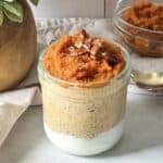 side view of pumpkin chia pudding in a mason jar.