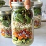human hand holding a mediterranean salad jar 2